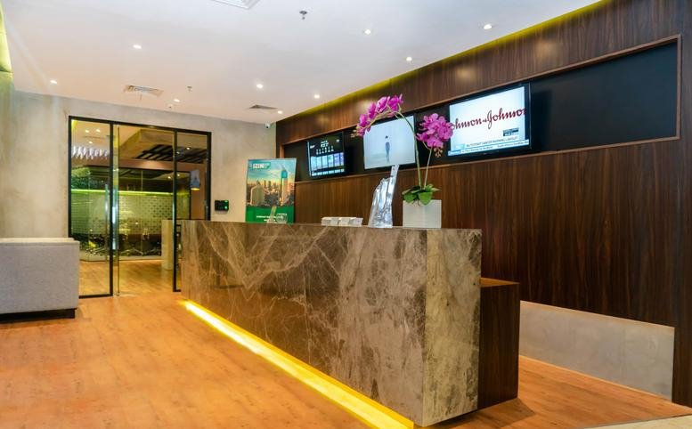 The sleek reception area at Centennial Tower L29D, E featuring a marble desk and warm under-counter lighting.