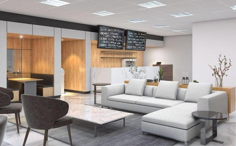 Spacious communal lounge at Centennial Tower with grey sectional seating and a coffee bar.