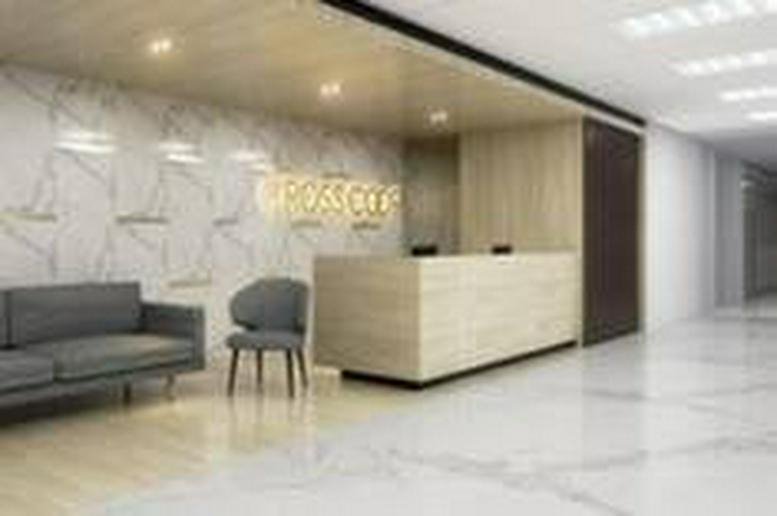 Reception area at Centennial Tower, 35th Floor, featuring a light wood desk and marble-patterned wall.