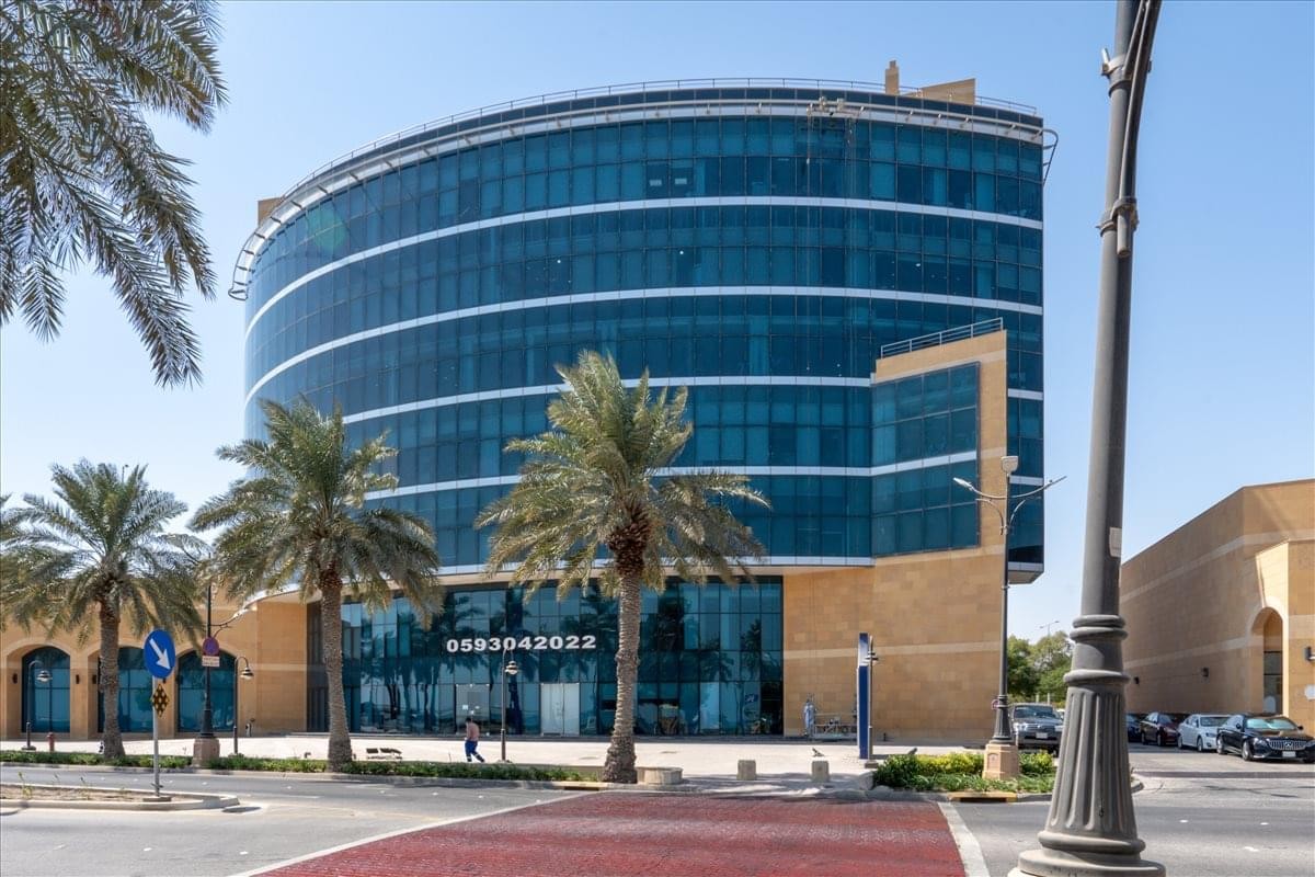 Exterior view of the curved glass facade of the Chamber of Commerce Building.