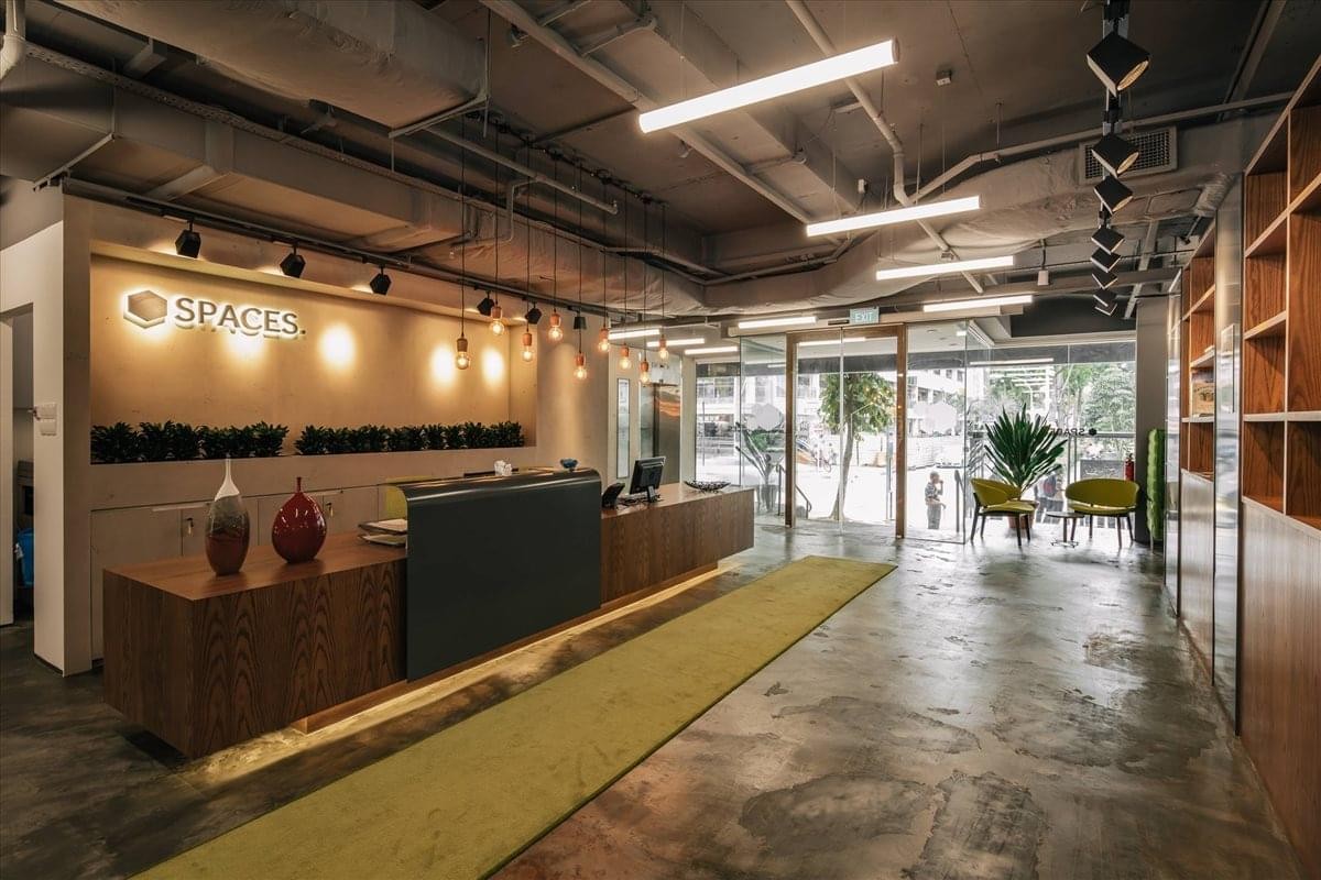 Warm reception area at City Hall, 410 North Bridge Road, Singapore with wood finishes and a green runner rug.