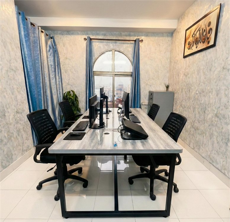 Meeting room at 9th Floor, Committee Chowk, Chaklala Road, Rawalpindi, Pakistan with marble-effect walls and arched window.