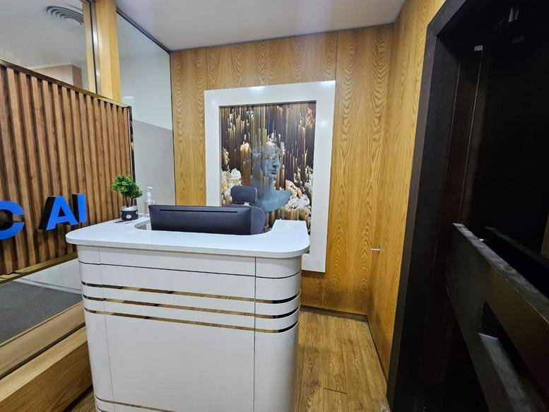 Bright reception desk at Concord Tower, Dubai Media City featuring wood panelled walls and modern artwork.