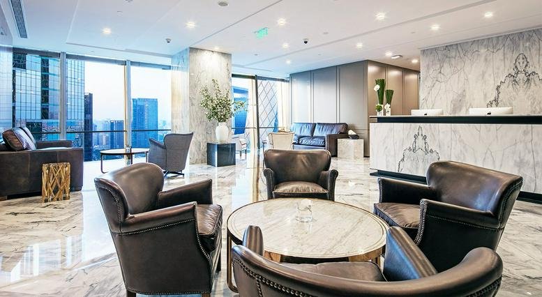 Elegant reception area with marble floors and plush armchairs.