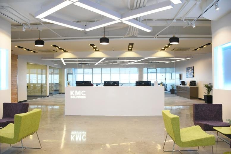 Spacious reception area of the Cyber Sigma Building with a sleek white desk and modern seating.