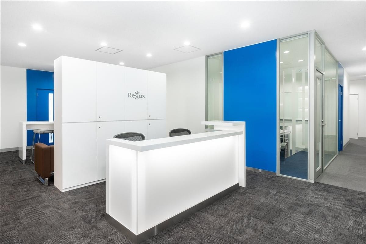 Bright, modern reception area of the Daiei Ginza Building with a white front desk and blue accents.