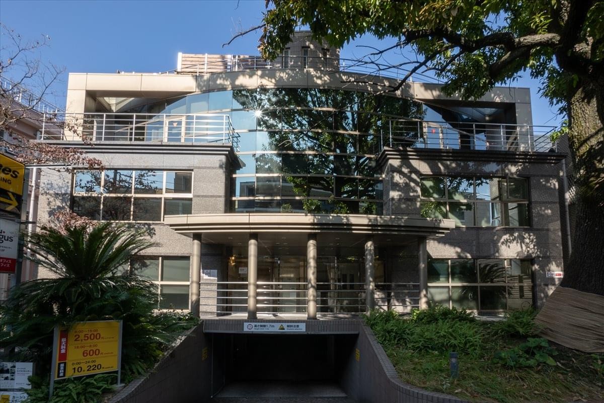 Exterior view of the glass and stone facade of the Frances Building in Daikanyama.