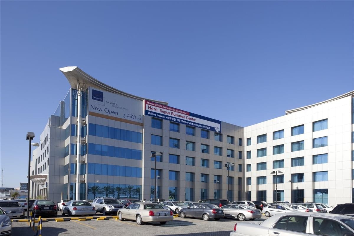 Exterior view of the modern stone and glass facade of Novotel Business Park.