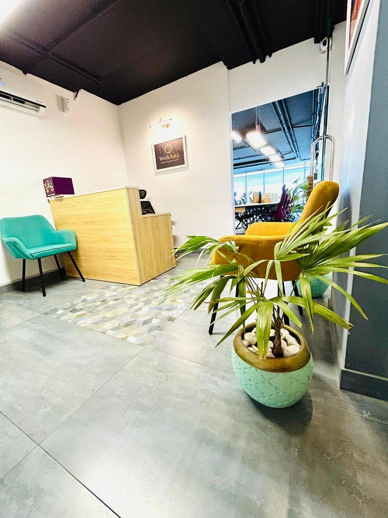Professional reception area of the Dilkusha Forum with a wood-fronted desk and teal armchair.