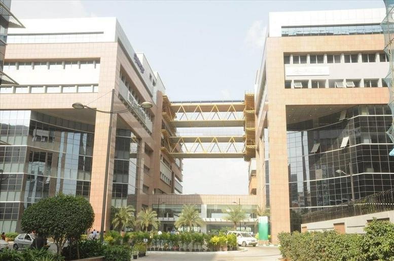 Exterior view of the twin-tower glass and stone facade at DivyaSree Omega.