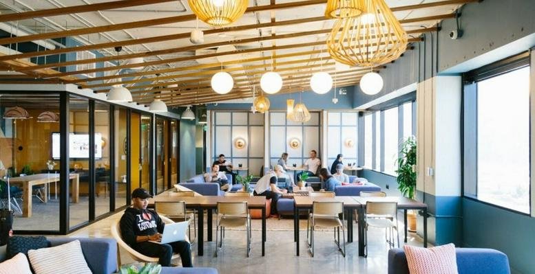 Spacious communal lounge at DLF Forum, DLF Cybercity, Phase III, Gurugram with wooden ceilings and wicker lighting.
