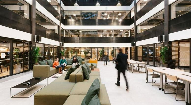 Spacious multi-level atrium at DLF Two Horizon Centre DLF Phase 5, Gurugram with lounge seating and greenery.