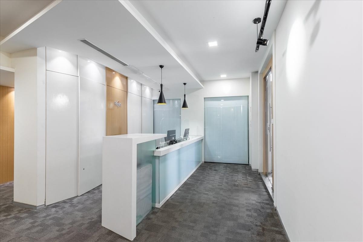 The bright and modern white reception area at DNR 90, Unit Nos. 301, 569/3, MG Road.