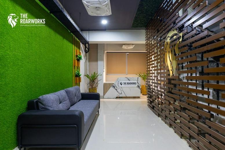 Modern reception lobby at Eagle Plaza, Blue Area, Islamabad, Pakistan with a green feature wall and wood paneling.