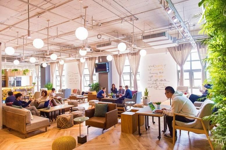 Spacious communal lounge at East Gongxiao Building with wooden floors and various seating clusters.