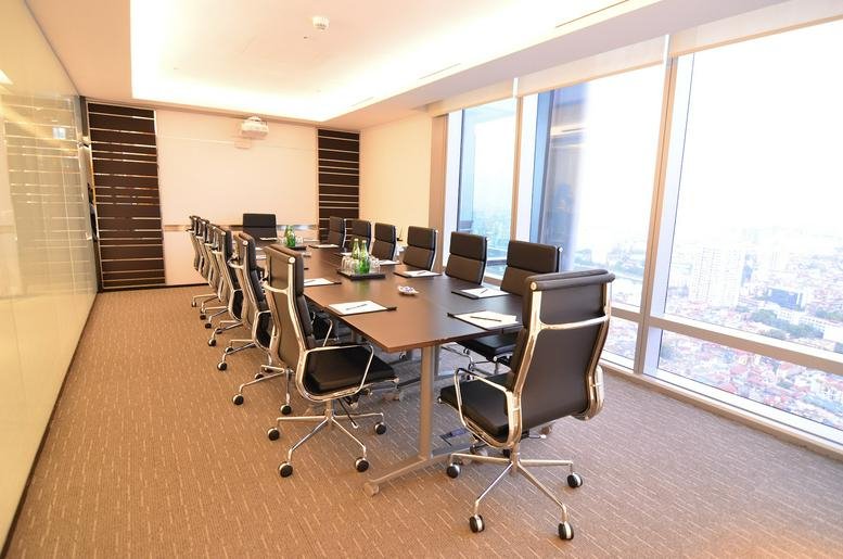 Spacious boardroom at Hanoi Lotte Center featuring a long table and floor-to-ceiling windows.