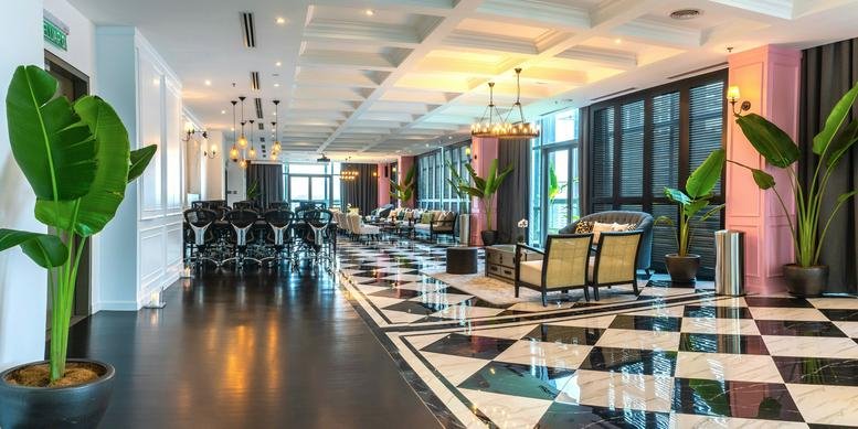 Luxurious lounge at EcoCity, Boutique Office 1 (B-01-D), Menara 2 (Pillar 11) with checkered floors and large plants.