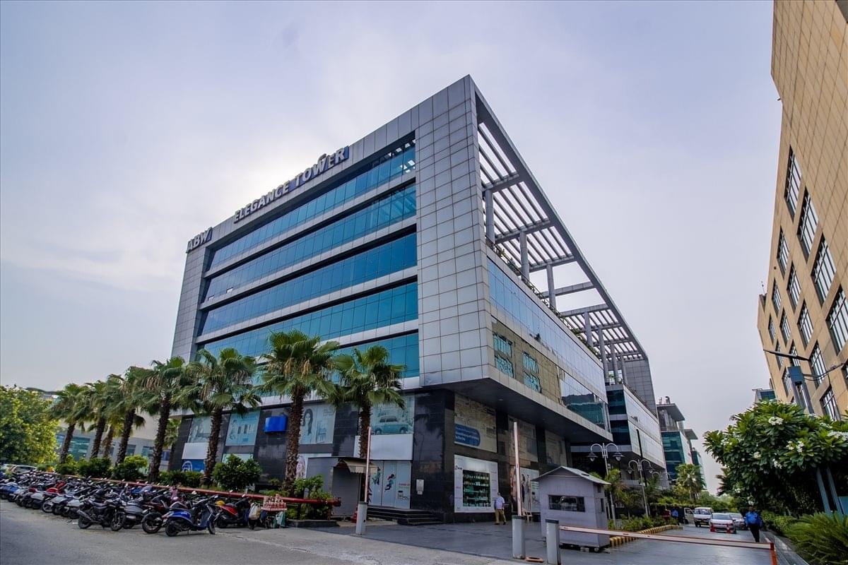 Exterior view of the contemporary glass-facade building at Elegance, Jasola District Centre.