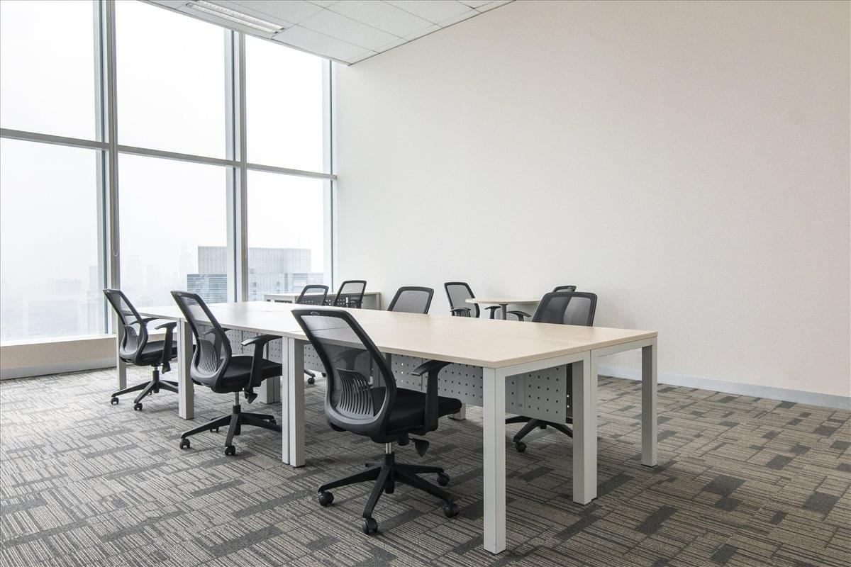 Meeting room at Equity Tower with floor-to-ceiling windows and mesh chairs.