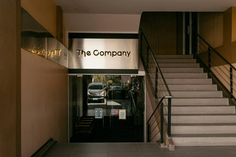 Ground floor entrance to JDN Square Building 4 featuring modern stairs and glass doors.