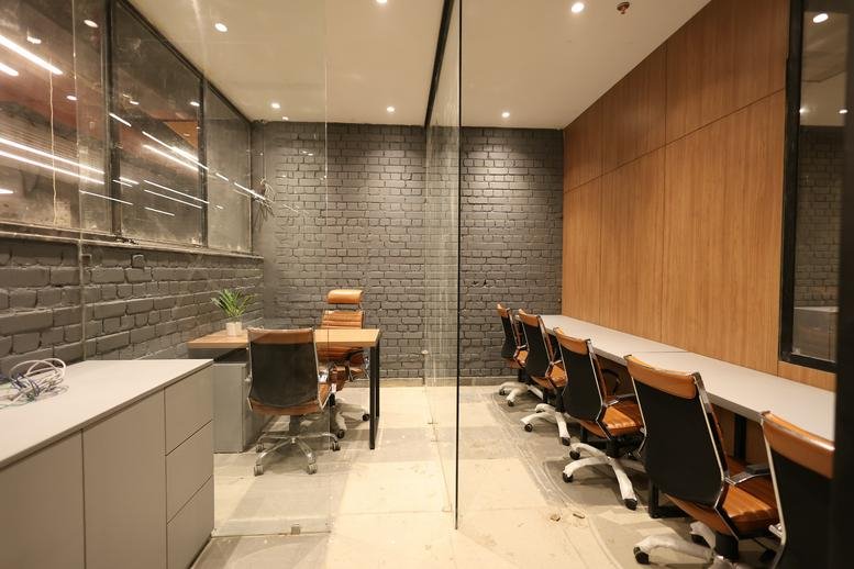 Large professional workspace at Galaxy Blue Sapphire Plaza featuring modern desks and industrial lighting.