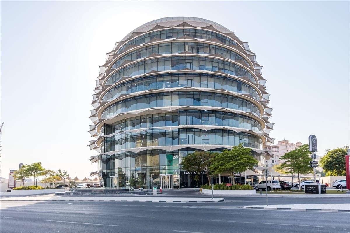 Exterior view of the curved glass-facade Gath Building, Ramada Junction, Doha.