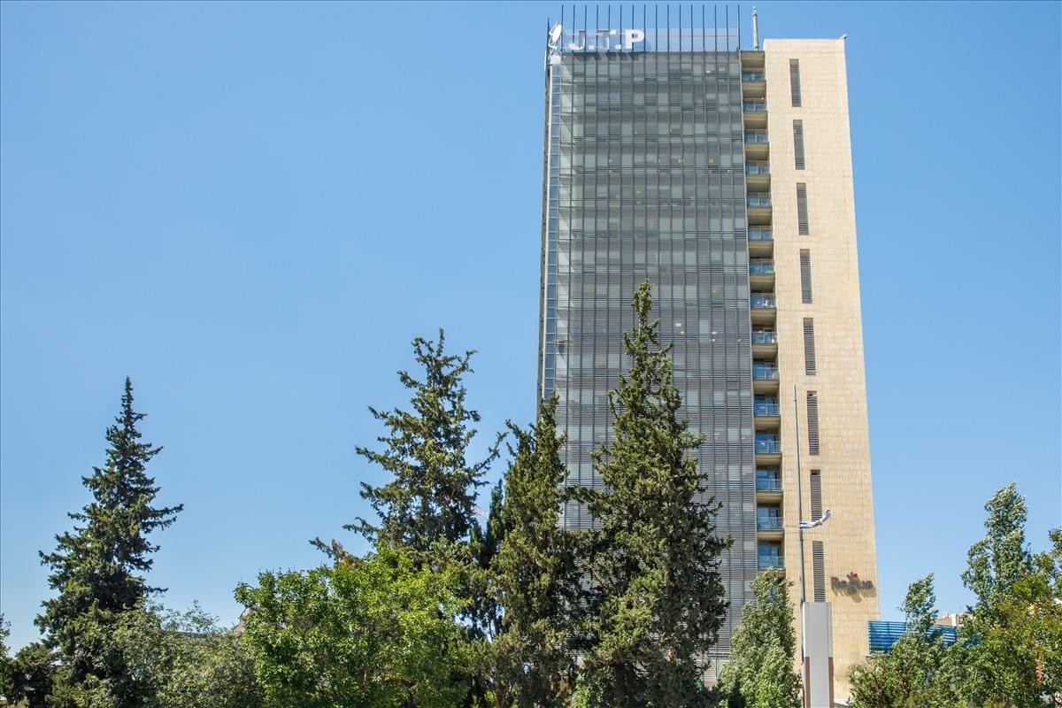 Exterior view of the glass and stone facade at Gati Tower.