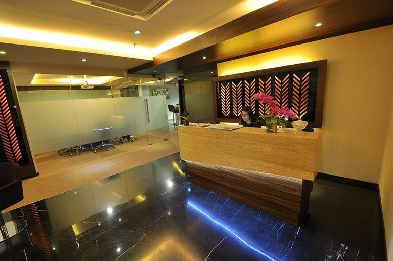 Professional reception desk at Grand Slipi Tower with warm lighting and floral accents.