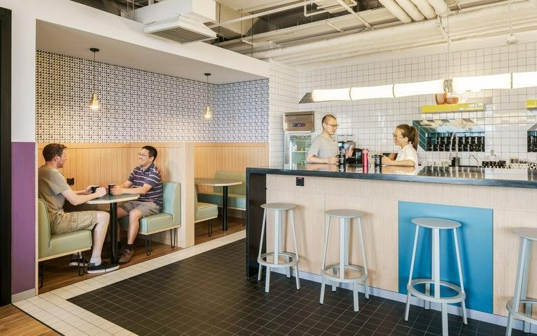 Bright café area at Gwanghwamun, 50 Jong-ro 1-gil Jongno, Seoul with booth seating and a service counter.