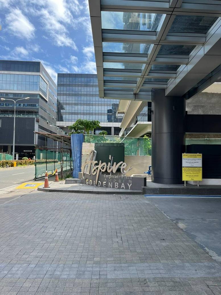 Branded signage at the Business Centre, Pasay City, Metro Manila, Philippines entrance under a glass canopy.
