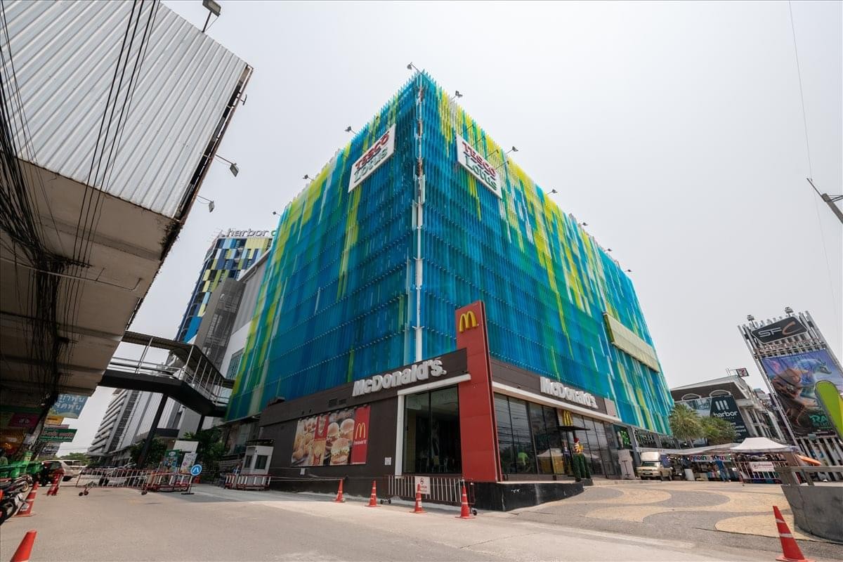 Exterior view of the Harbor Mall building featuring a green and blue facade.