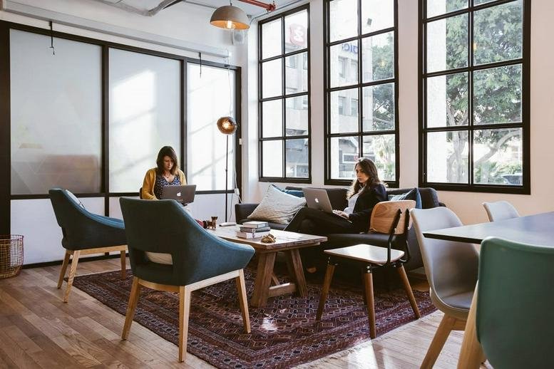 Bright coworking lounge at Hazerem, 7 HaPelech Street with comfortable seating and natural light.