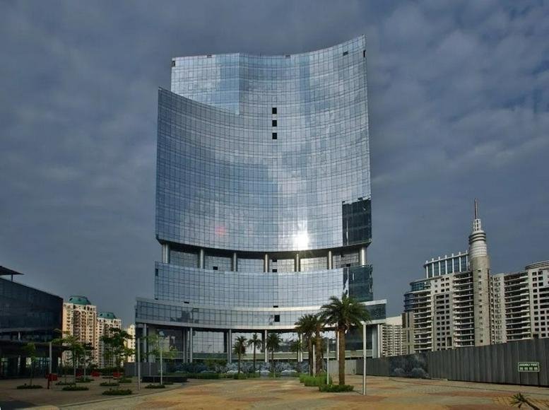 Exterior view of the curved glass-facade skyscraper at Horizon Centre 2, Golf Course Road, Gurgaon, India.