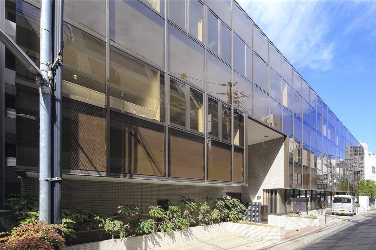 Modern glass exterior of the Hoshino Building, 8-11-10 Nishi-Shinjuku, Tokyo.