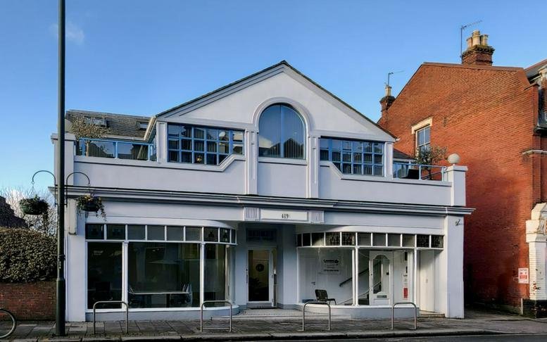 Exterior street view of the Hung Kuo Building with a classic facade and arched window.