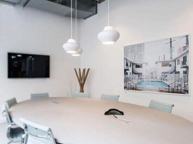Spacious boardroom at Innovative Financial Building with a large oval table and modern pendant lighting.