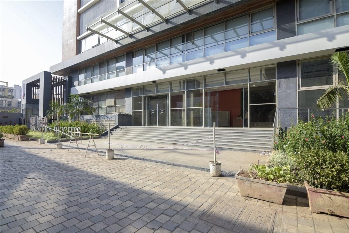 Exterior view of the glass-facade Inspire Hub, Western Heights building with a paved entrance courtyard.