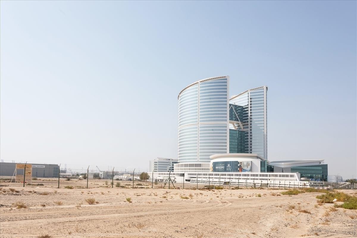 The modern curved glass towers of JAFZA ONE standing against a clear sky.