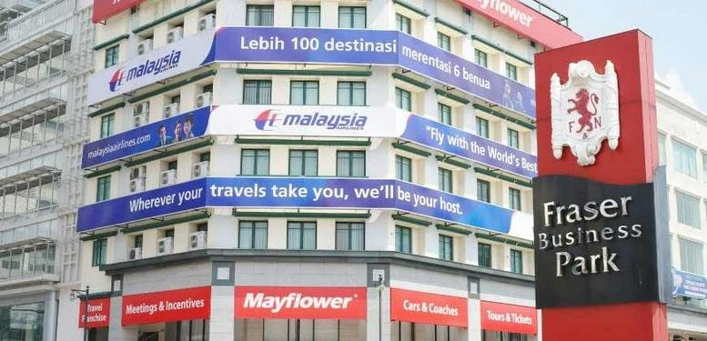 Exterior view of the Fraser Business Park building with Malaysia Airlines banners and a red monument sign.