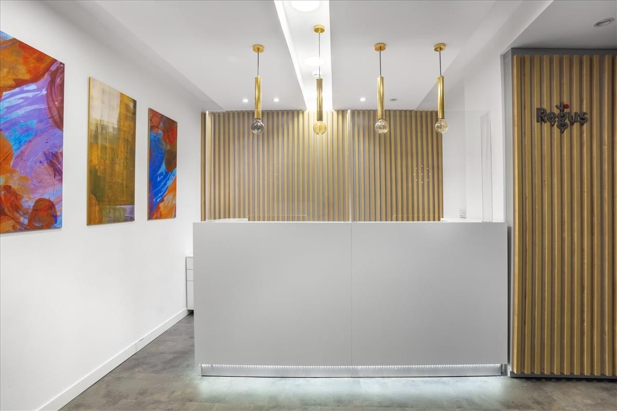 Modern reception area at Kısıklı Cd No:28, Altunizade. featuring a white desk and colorful abstract art.