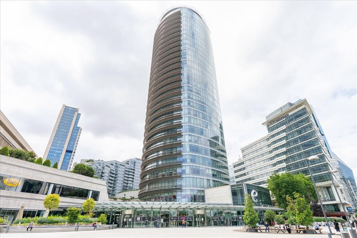 Exterior view of the curved glass facade at Kanyon, Buyukdere Caddesi No. 185.