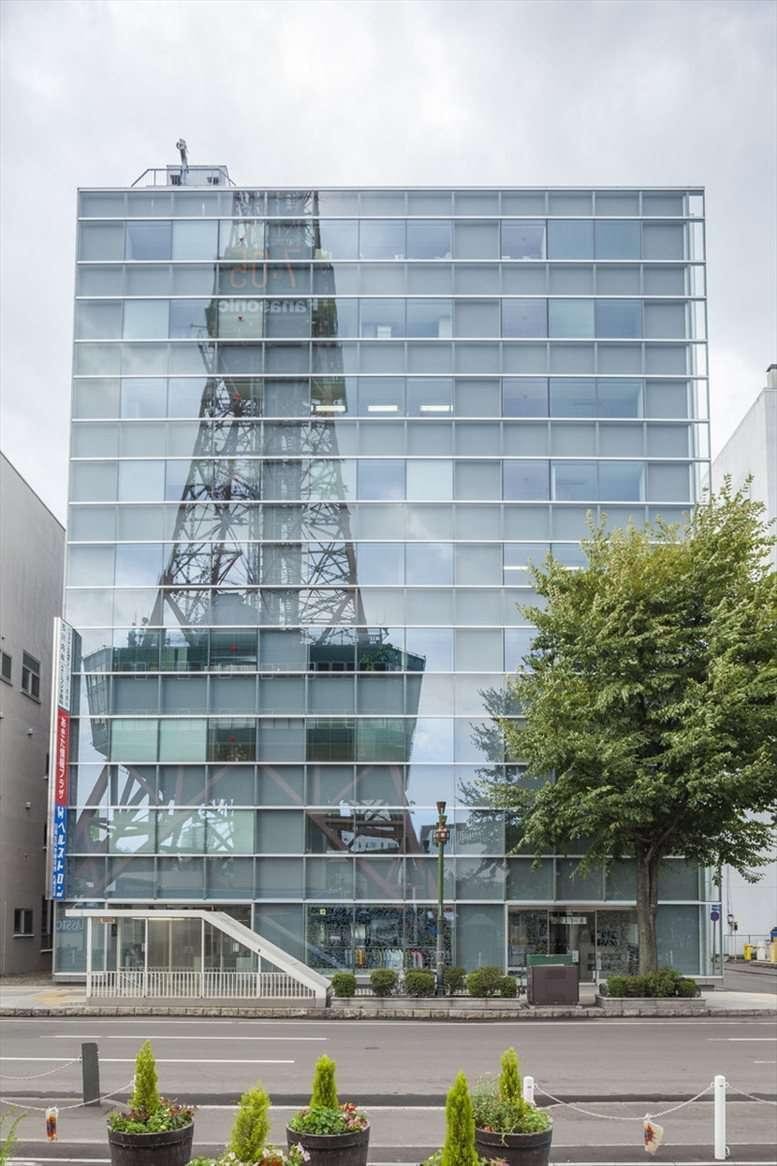Modern glass exterior of the 9F Keiwa Odori Building 50 reflecting the Sapporo TV Tower.