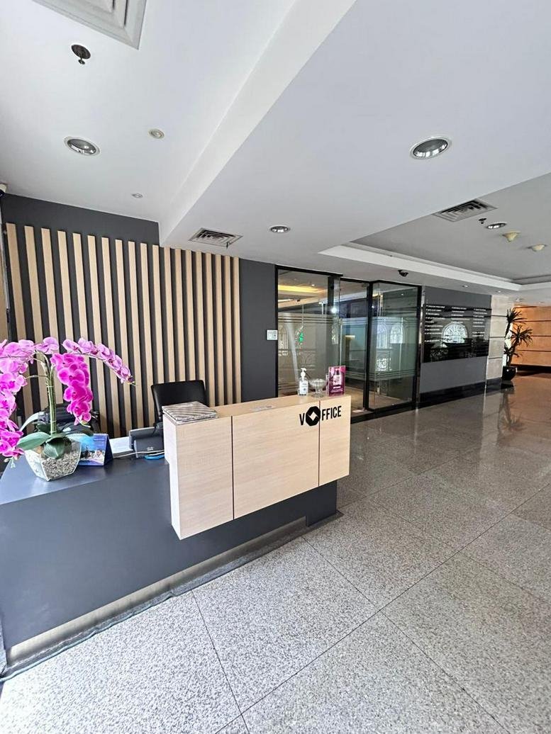 Reception area with desk and orchid decoration.