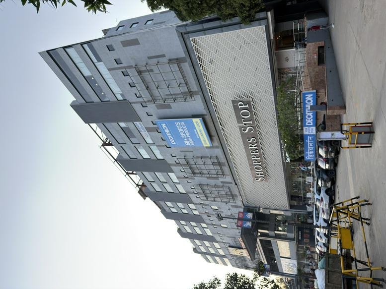 Exterior view of Keshar Towers, a multi-story commercial building with modern glass and grey panels.
