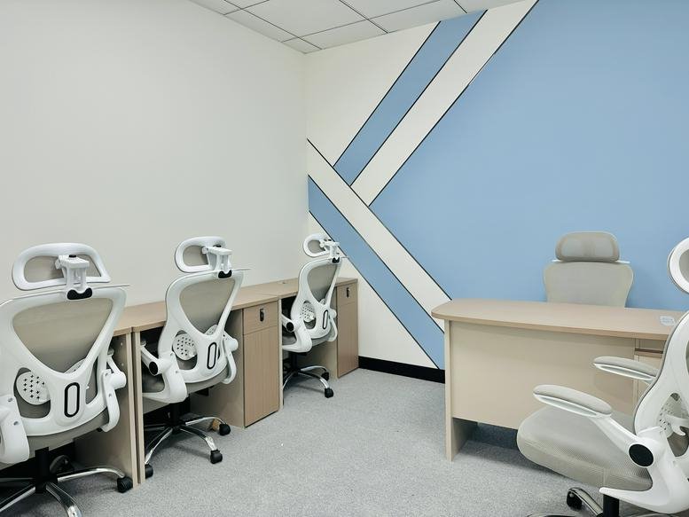 Spacious interior office at Burjuman Business Tower with ergonomic chairs and feature wall.