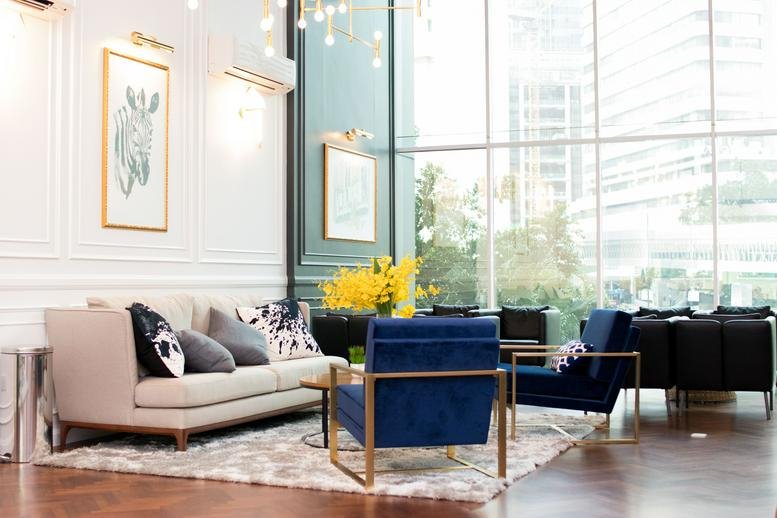 Bright lobby at KLCC, 6, Jalan Kia Peng with plush cream sofas and blue velvet armchairs.