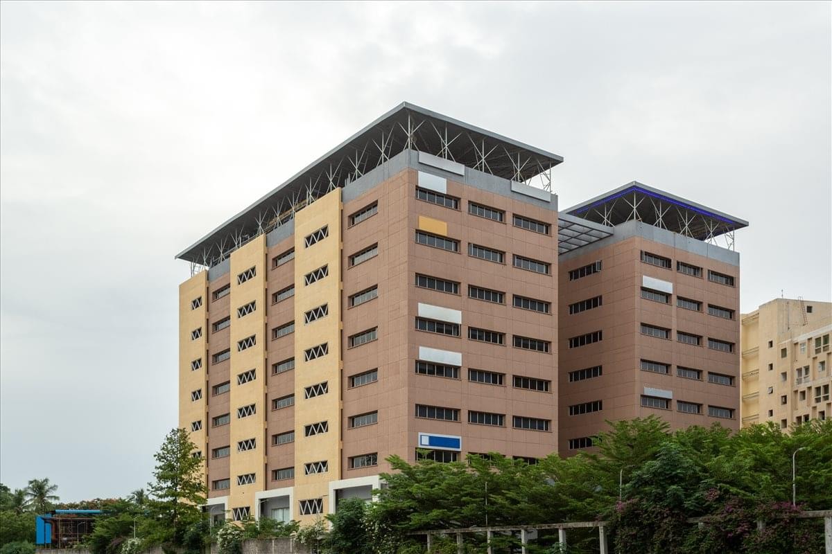 Exterior view of the multi-story KRM Plaza building with its distinctive brick facade.