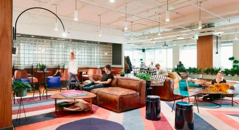 Spacious communal lounge at Leading Center, 3 Xi Yu Jie, East Tower, Chengdu with leather sofas and vibrant rugs.