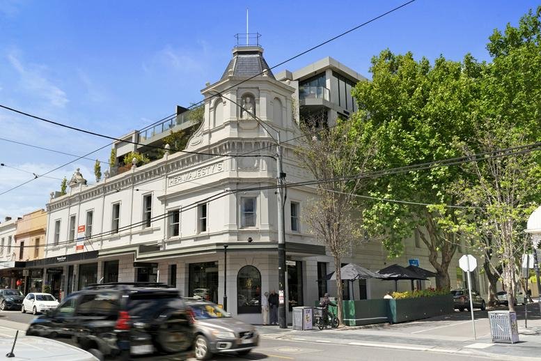 Exterior street view of the corner heritage building under a blue sky.
