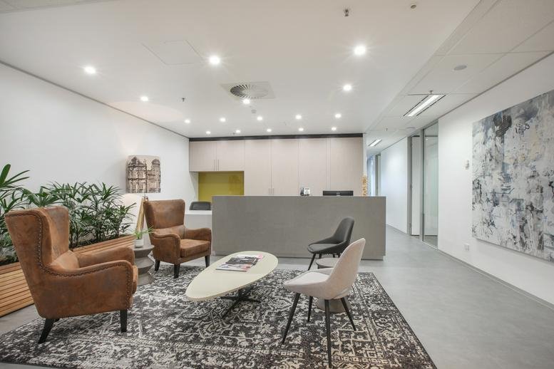Spacious reception area with leather armchairs and modern art at 167 Eagle Street, Brisbane, Queensland.
